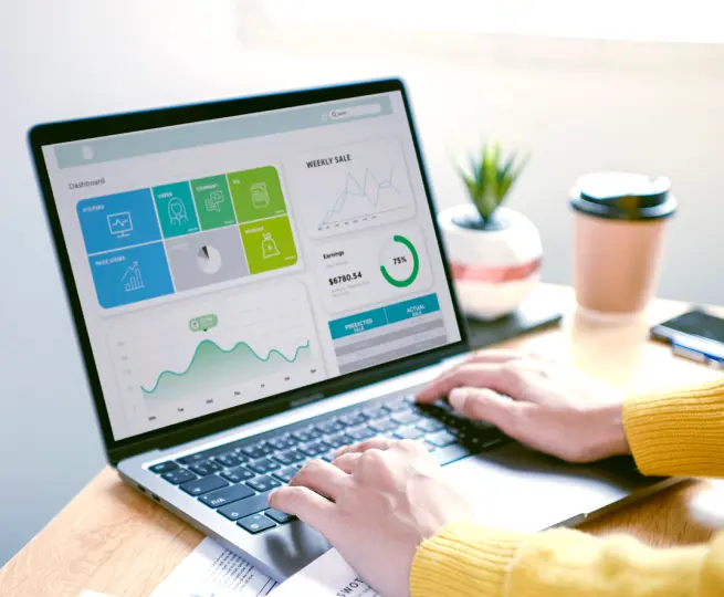 Person analyzing data on laptop screen with charts.